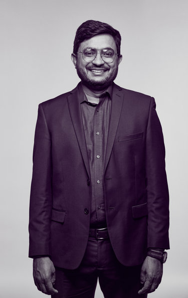 Dr Sabar, an oncologist, wearing a suit and smiling at the camera